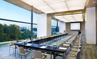 A conference space with spacious rooms featuring large windows and long tables for meetings at EAST Beijing