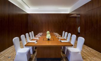 There is a spacious conference room with wooden walls and a long table that can accommodate up to 10 people at the Westin Xi'an