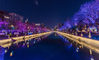 At night, the lights reflect off the water and trees on both sides of the city at UChoice Hotel