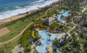 an aerial view of a resort with a large pool and a beach in the background at Shangri-La's Hambantota Golf Resort and Spa, Sri Lanka