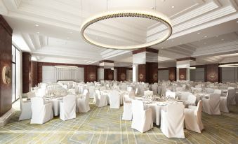 a large banquet hall with white tablecloths and chairs , ready for a formal event or a formal event at Athens Marriott Hotel