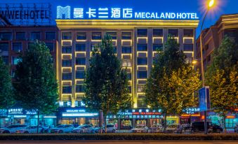 The hotel building is illuminated with neon lights at night at Yiwu Mankalan Hotel (International Trade City Xinguanghui Branch)