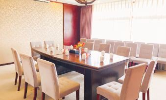 a large conference room with a long table surrounded by chairs and a chandelier hanging from the ceiling at Grace Hotel