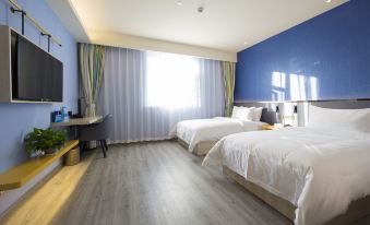 A room with two beds, a TV, and a large window in the center, all on a wooden floor at Ibis Styles Hotel (Beijing Capital Airport)