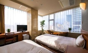 a hotel room with two beds , a television , and a window overlooking a city view at Sun Palace Hotel