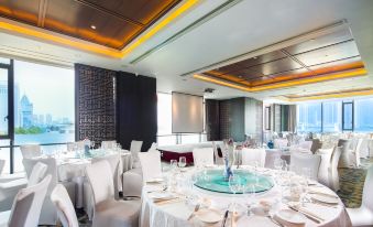 A ballroom at the hotel is equipped with tables and chairs for hosting events at Hotel Indigo Shanghai on The Bund