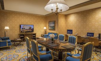 The room is equipped with a large table and chairs positioned in front of a television for entertainment purposes at The Parisian Macao