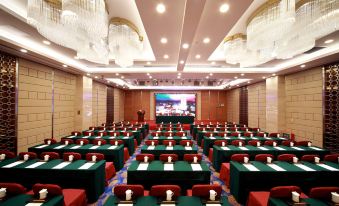a spacious conference room with rows of green chairs at Hotel Landmark Canton Guangzhou