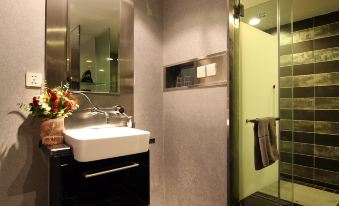 The upper floor living area includes a bathroom with a sink, mirror, and shower at FX Hotel (Beijing Yansha)