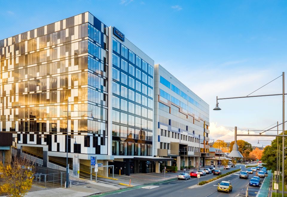 a modern office building with multiple floors and glass windows , situated in an urban environment at Mantra Albury Hotel