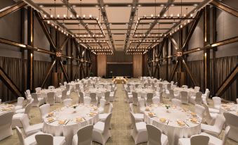 A ballroom is arranged for an event, with tables and chairs placed in the center at Novotel Shanghai Clover