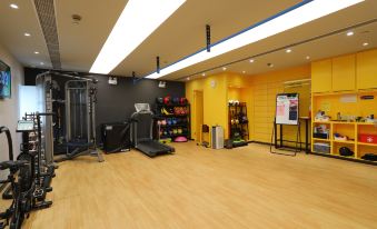 The room is equipped with an exercise area and weight training equipment in the center at Jinjiang Metropolo Classiq Jing'An Hotel