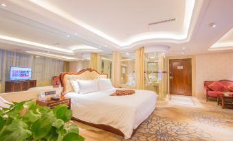 The middle room features a spacious bed, an attached bathroom, and a sitting area adjacent to it at Longyou International Grand Hotel
