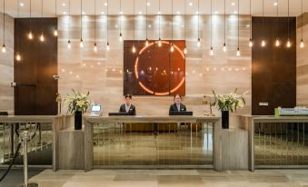 The hotel's front desk and reception area are bustling with people in its main lobby at Yunrui Hotel, Zhongshan Park, Shanghai