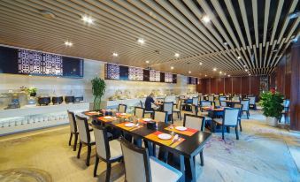 a modern restaurant with a bar and dining area , where several people are seated at tables at Fuzhou Hotel