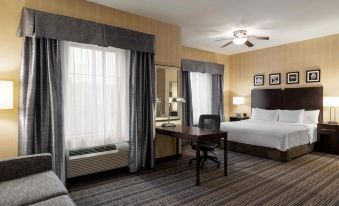 a hotel room with a king - sized bed , a flat - screen tv , a desk , and a couch at Homewood Suites by Hilton Newtown - Langhorne