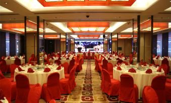 A ballroom is arranged for an event, with tables and chairs placed in the center at Jinglun Hotel