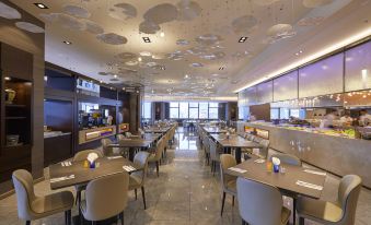 The restaurant features a central area with tables and chairs, as well as an open concept dining room at Caesar Metro Taipei