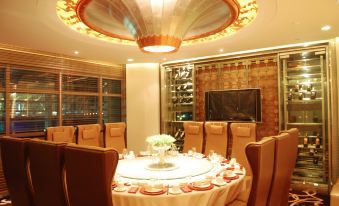 There is a large room with an oval table and chairs in the middle, accompanied by another item at Da Zhong Airport Hotel