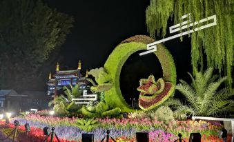 The world's largest floral display at night features a prominent tree and various other plants at CitiGO Hotel Beijing Tian'anmen Square