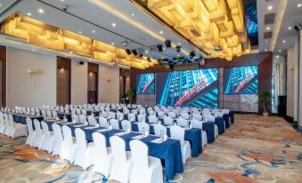The ballroom is arranged with tables and chairs for an event at Maision New Century Hotel Keqiao Shaoxing
