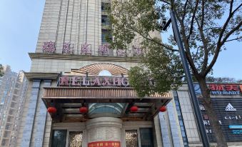 the exterior of a modern building with chinese characters on the sign , and a red sign hanging from the entrance at Relax Hotel