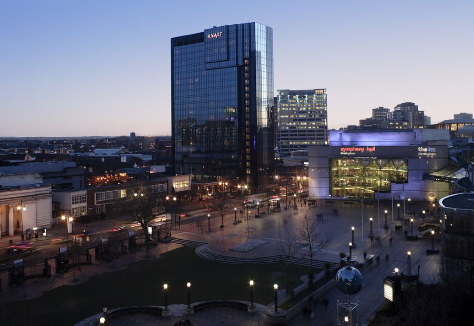 a cityscape at dusk , with a tall building in the foreground and several smaller buildings surrounding it at Hyatt Regency Birmingham