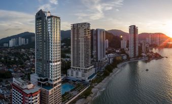 aerial view of a city with tall buildings and a body of water in the background at Hompton Hotel by The Beach