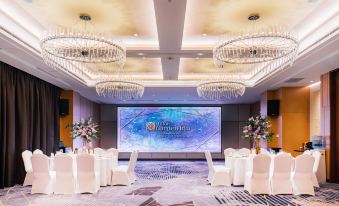 A ballroom is arranged for an event, with tables and chairs positioned towards the front wall at Hilton Garden Inn Shanghai Hongqiao NECC