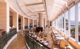 The restaurant features large windows and tables in the middle, as well as an indoor dining room at Harbour Plaza Metropolis
