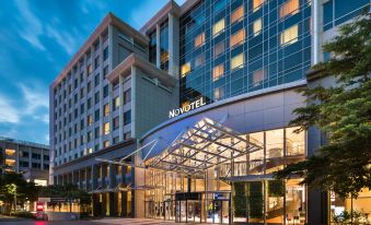 "a modern hotel building with its name "" marriott "" displayed above the entrance , lit up at night" at Novotel Taipei Taoyuan International Airport