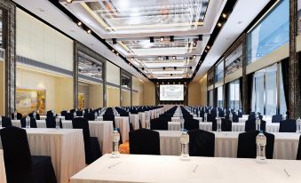 A spacious ballroom is arranged with tables and chairs for an event at Elegant Hotel Shanghai Bund