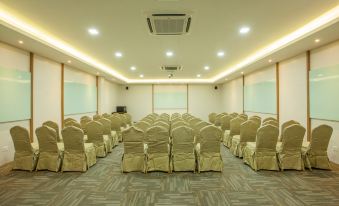 a large conference room with rows of chairs arranged in a semicircle , ready for a meeting or event at Bzz Hotel Skudai