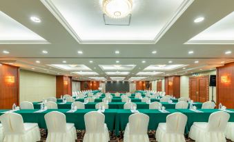 A large ballroom is arranged for a wedding, featuring tables and chairs in the center at Metropark Hotel Shenzhen