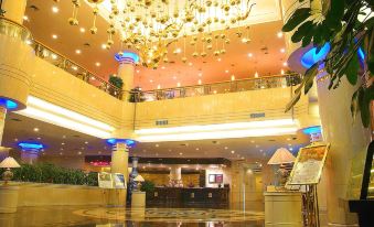 a large hotel lobby with high ceilings , a gold chandelier , and multiple floors of seating at Phoenix Hotel