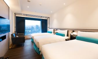 This room features double beds and large windows with a view of the city's downtown area at Caesar Metro Taipei