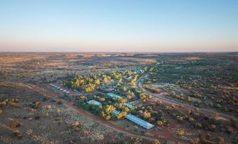 aerial view of a rural area with a group of small houses and trees , surrounded by a vast landscape at Discovery Resorts - Kings Canyon