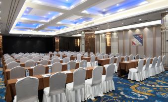 a large conference room with rows of chairs and tables , all facing the same direction at Relax Hotel