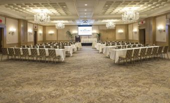 a large conference room with rows of chairs and tables set up for a meeting or event at The Townsend Hotel