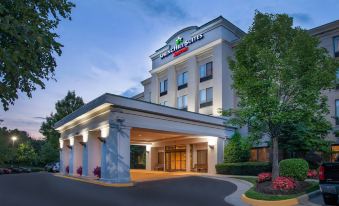 "a large building with a green sign that reads "" springhill suites "" is shown at dusk" at SpringHill Suites Centreville Chantilly