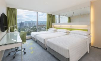 The bedroom features double beds, large windows, and a city view at Dorsett Tsuen Wan