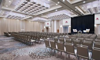 a large conference room with rows of chairs arranged in a semicircle , providing seating for attendees at Guyana Marriott Hotel Georgetown