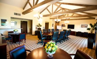 a large conference room with wooden beams on the ceiling , a table , chairs , and a vase of flowers at Hyatt Vacation Club at the Welk, San Diego