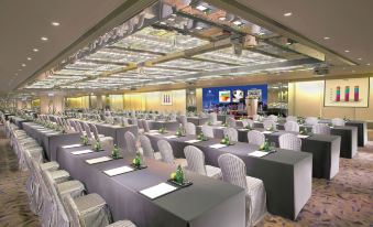 A spacious room at the hotel arranged with rows of tables for events or functions at Regal Kowloon Hotel