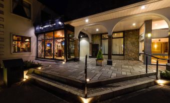 "a brick building with a sign that reads "" sorrento hotel "" is illuminated at night" at The Inn at Dromoland