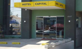 "the entrance of a hotel with a yellow sign that says "" hotel capital "" and glass doors" at Hotel Capital