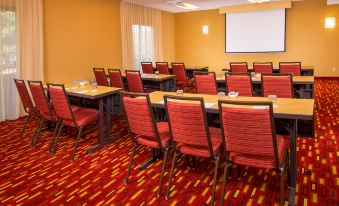 a conference room with multiple tables and chairs arranged in rows , ready for a meeting or event at Courtyard Manassas Battlefield Park