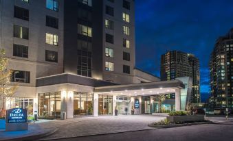 "a modern hotel entrance at night , with the building 's name "" hilton "" displayed prominently on the sign" at Delta Hotels by Marriott Waterloo