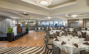 a large dining room with tables and chairs arranged for a group of people to enjoy a meal at Crowne Plaza Suffern-Mahwah, an IHG Hotel