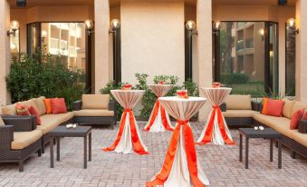 a patio area with several tables and chairs set up for an event , possibly a wedding or a party at Courtyard by Marriott Las Vegas Convention Center